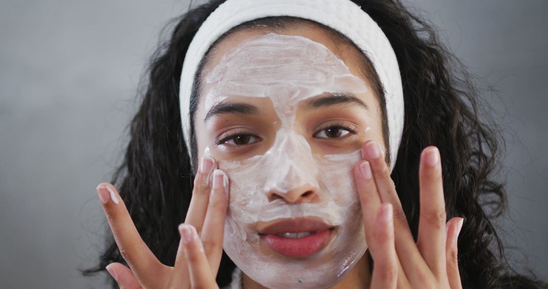 Woman applying face mask and relaxing with skincare routine - Free Images, Stock Photos and Pictures on Pikwizard.com