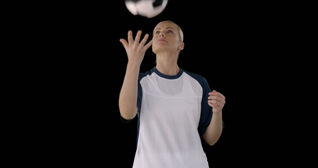 Confident Female Soccer Player Juggling Ball Isolated on Black - Free Images, Stock Photos and Pictures on Pikwizard.com