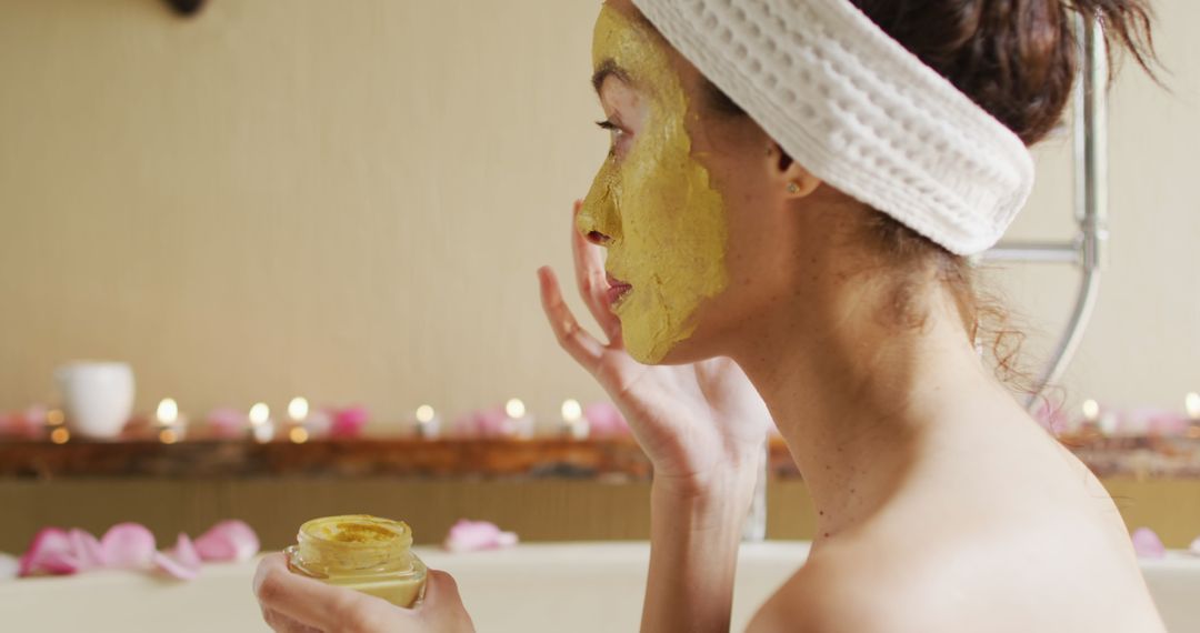 Woman with Vitiligo Applying Face Mask in Relaxing Home Spa