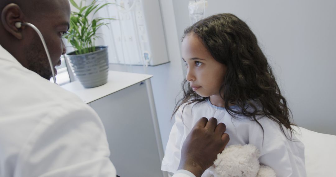 Caring Doctor Examining Young Girl in Clinic - Free Images, Stock Photos and Pictures on Pikwizard.com