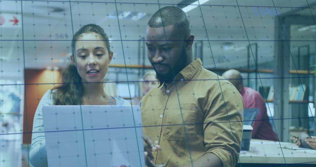 Analyzing Data on Laptop in Modern Office Environment