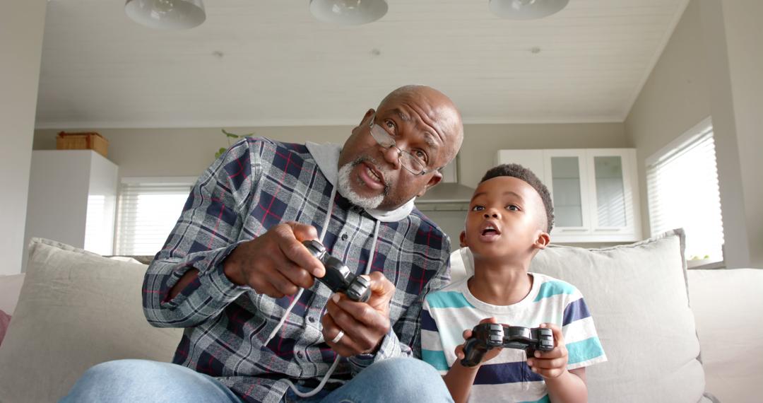 Grandfather and Grandson Bonding While Playing Video Games at Home - Free Images, Stock Photos and Pictures on Pikwizard.com