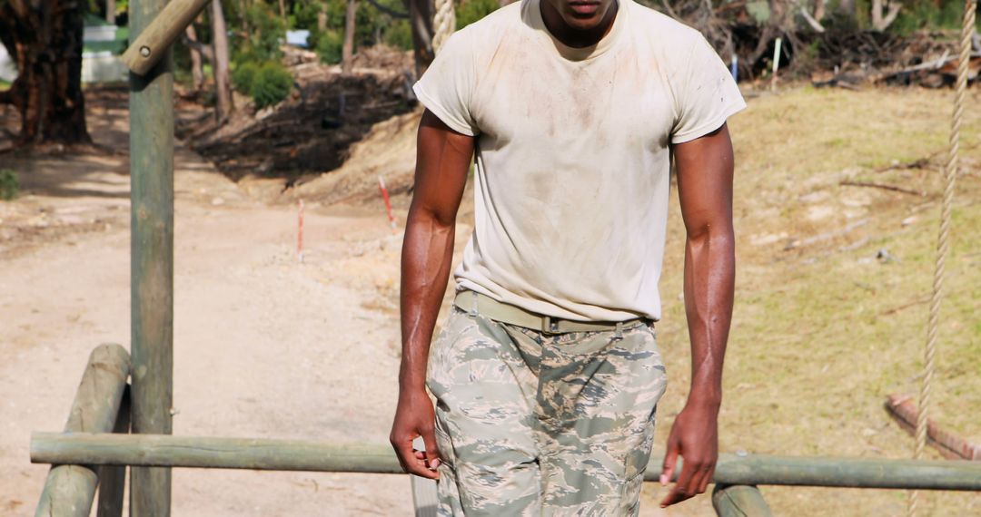 An African American soldier looks tired and dirty following intense outdoor training. - Free Images, Stock Photos and Pictures on Pikwizard.com
