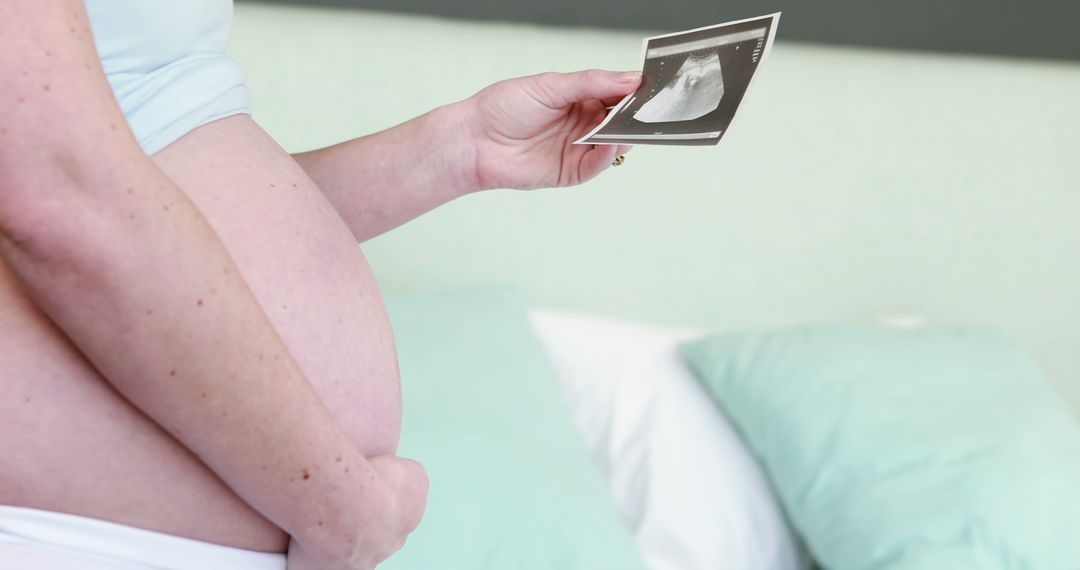 Pregnant Woman Holding Ultrasound While Anticipating Future - Free Images, Stock Photos and Pictures on Pikwizard.com