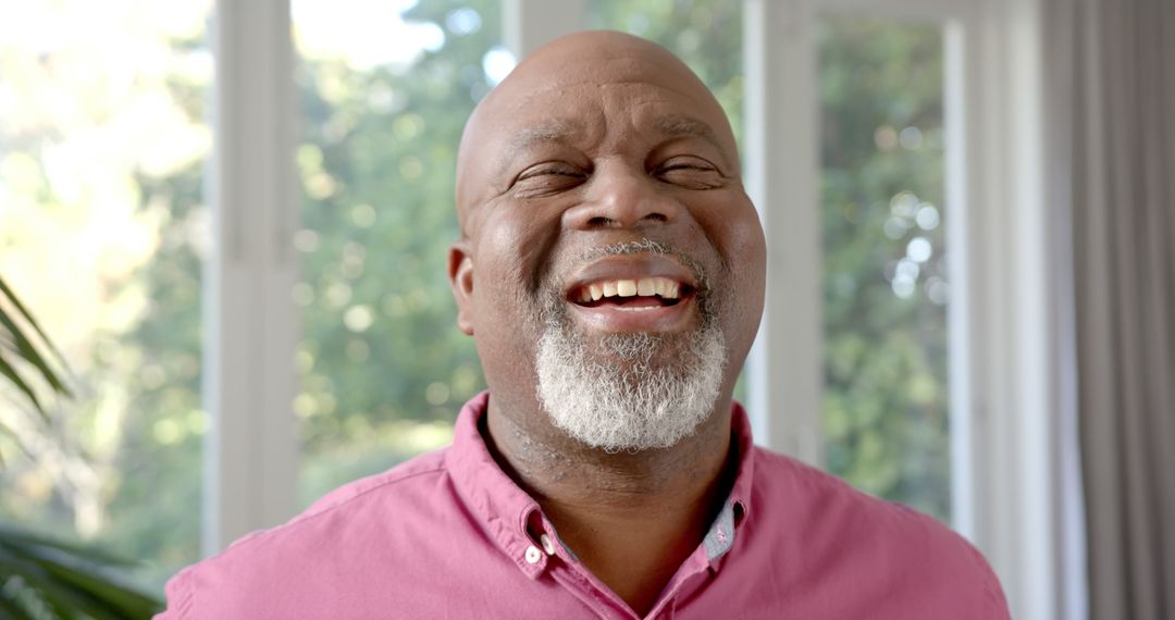 Joyful Senior Man Smiling in Bright Room - Free Images, Stock Photos and Pictures on Pikwizard.com