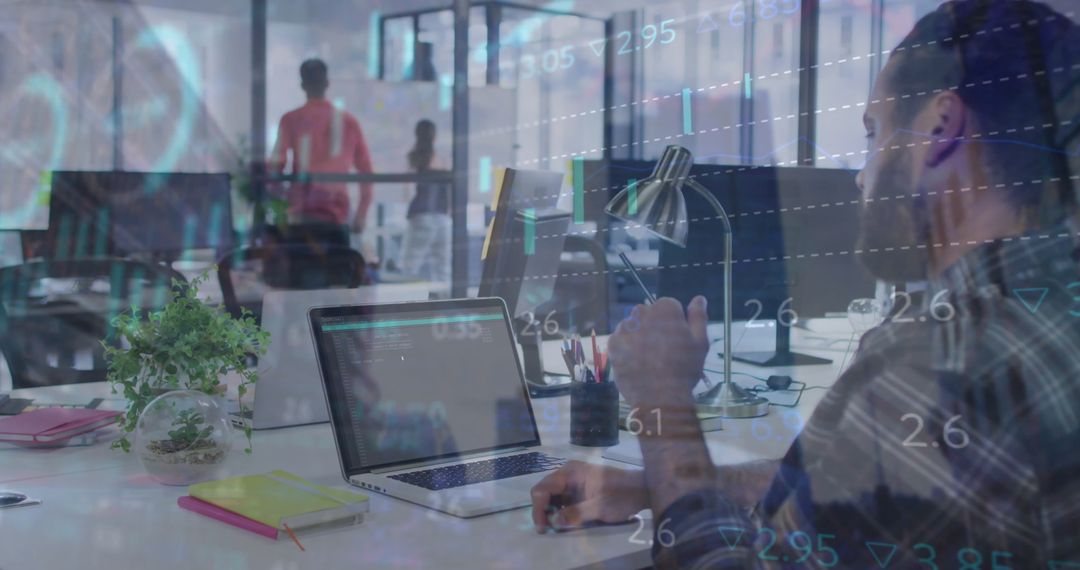 Businessman Analyzing Financial Data in Modern Office with Laptop