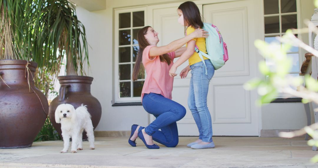 Mother Hugging Daughter Before School on Front Porch with Dog - Free Images, Stock Photos and Pictures on Pikwizard.com