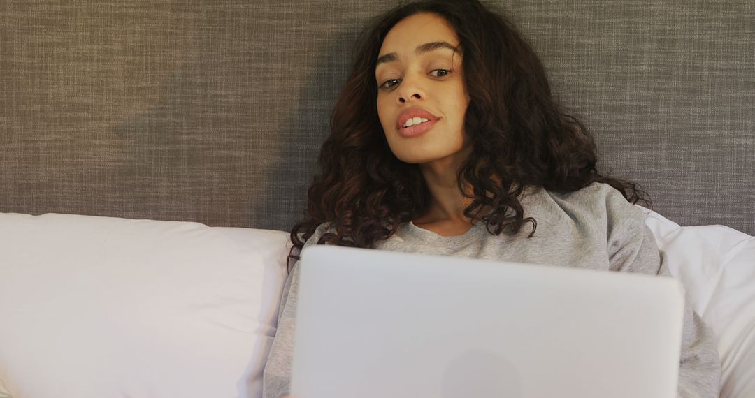 Young Woman Relaxing In Bed Using Laptop, Remote Work Concept - Free Images, Stock Photos and Pictures on Pikwizard.com