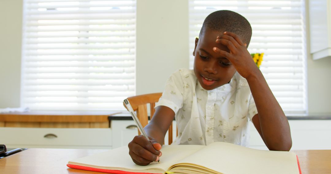 Young Boy Concentrating on Homework at Home - Free Images, Stock Photos and Pictures on Pikwizard.com