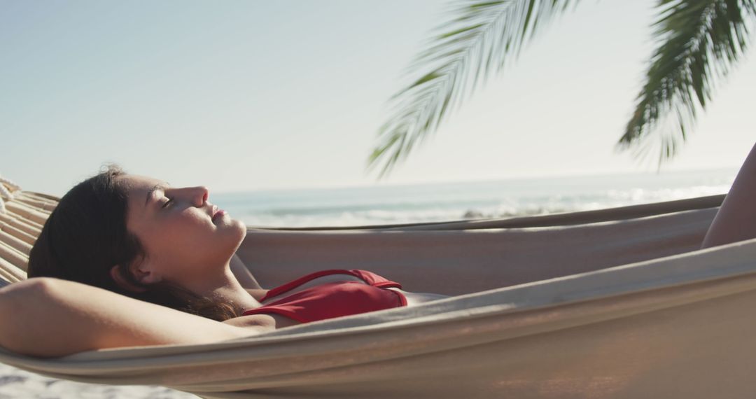 Young Woman Relaxing in Hammock on Peaceful Beach