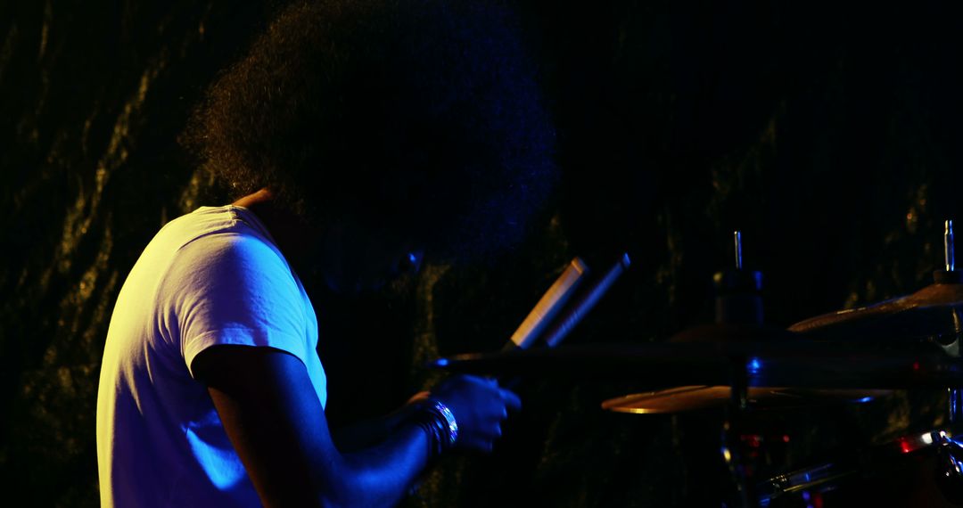 Silhouette of Drummer Performing Vibrant Nighttime Concert - Free Images, Stock Photos and Pictures on Pikwizard.com