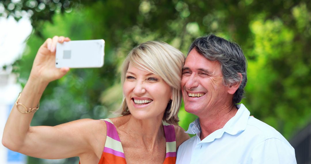 Smiling Mature Couple Taking Selfie Outdoors - Free Images, Stock Photos and Pictures on Pikwizard.com