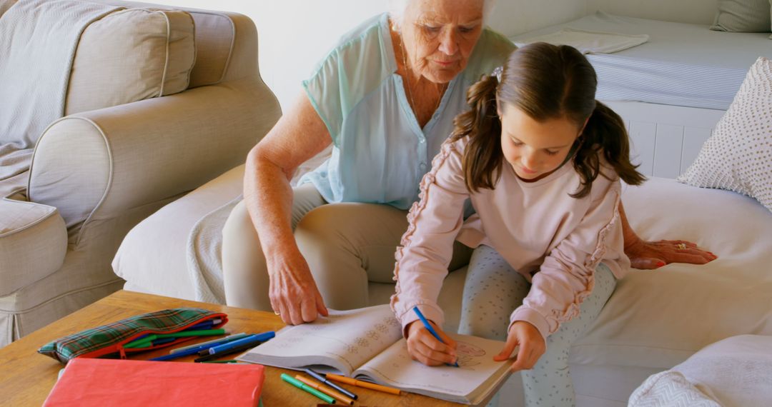 Grandmother Assisting Granddaughter with Drawing Homework at Home - Free Images, Stock Photos and Pictures on Pikwizard.com