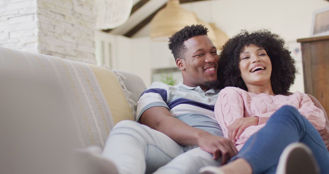 Joyful African American Couple Relaxing on Couch