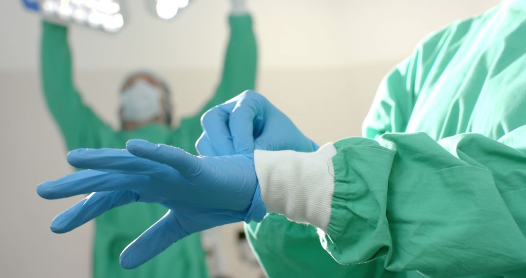 Surgeon Wearing Surgical Gloves in Operating Room Before Surgery - Free Images, Stock Photos and Pictures on Pikwizard.com