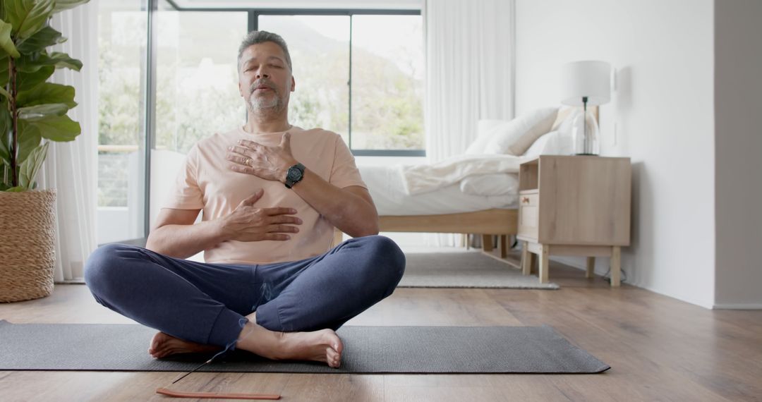 Middle-aged Man Practicing Mindfulness Meditation at Home - Free Images, Stock Photos and Pictures on Pikwizard.com