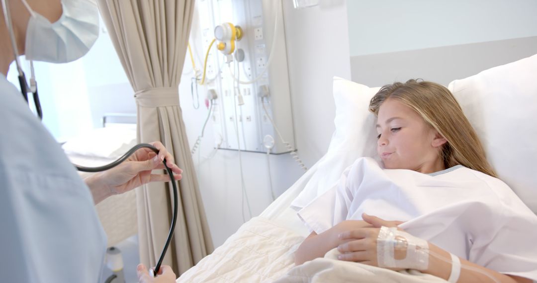 Doctor Examining Young Girl Patient in Hospital Bed - Free Images, Stock Photos and Pictures on Pikwizard.com