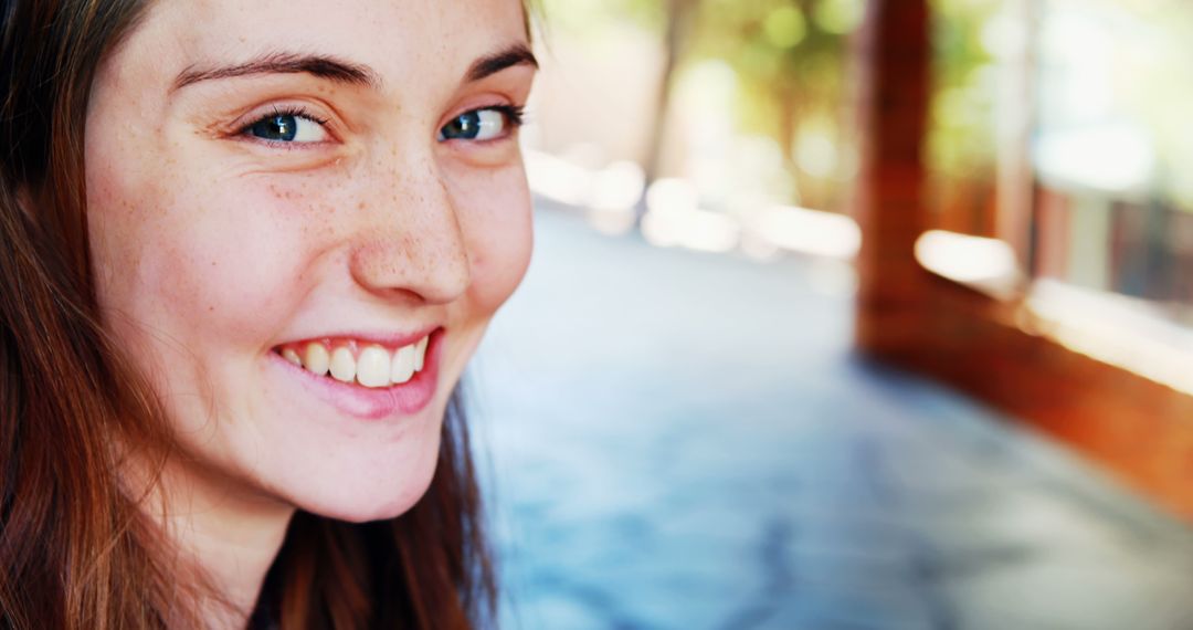 Close-Up of Smiling Young Woman with Freckles in Natural Light - Free Images, Stock Photos and Pictures on Pikwizard.com