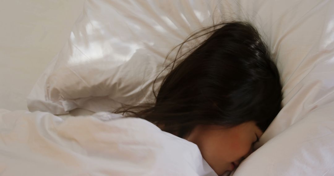 Woman sleeping peacefully on soft white pillows - Free Images, Stock Photos and Pictures on Pikwizard.com