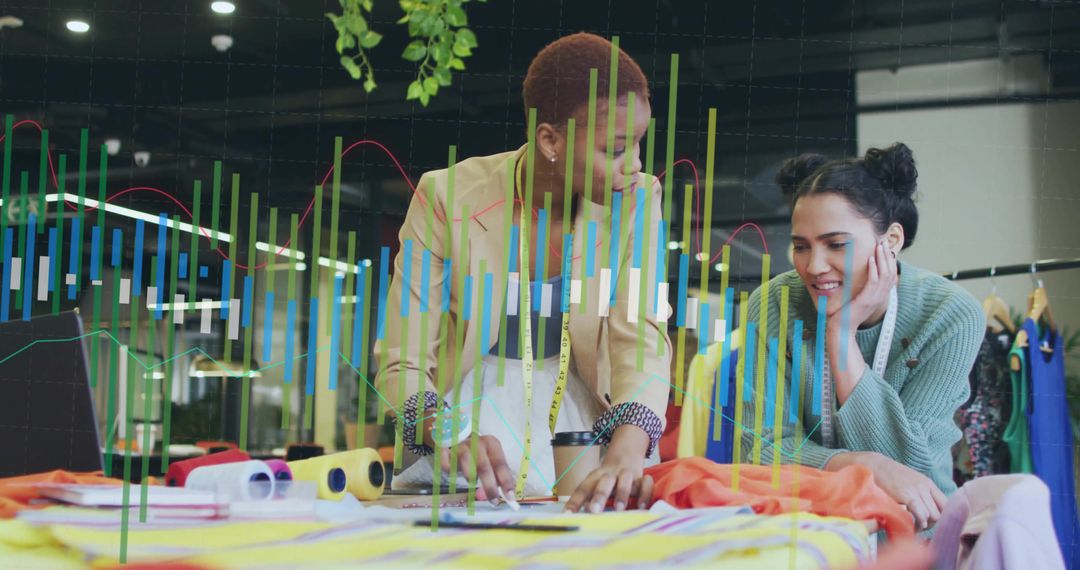 Fashion Designers Collaborating with Fabric and Sketches in Design Studio