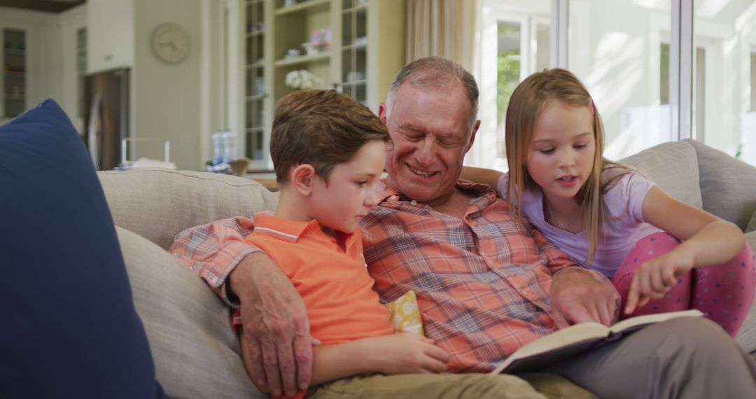 Grandfather Reading Story to Grandchildren on Sofa at Home - Free Images, Stock Photos and Pictures on Pikwizard.com