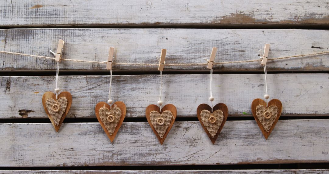 Rustic Heart Decorations Hanging Against Weathered Wooden Background - Free Images, Stock Photos and Pictures on Pikwizard.com