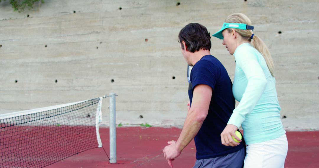 Couple Practicing Tennis Swing Together on Outdoor Court - Free Images, Stock Photos and Pictures on Pikwizard.com