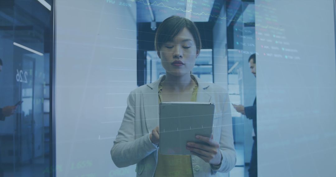 Businesswoman Analyzing Stock Market Data on Tablet Device