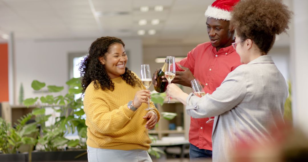 Colleagues Enjoying Office Holiday Celebration with Champagne - Free Images, Stock Photos and Pictures on Pikwizard.com