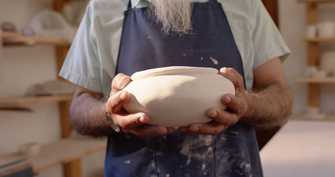 Potter Holding Freshly Crafted Ceramic Bowl in Studio - Free Images, Stock Photos and Pictures on Pikwizard.com