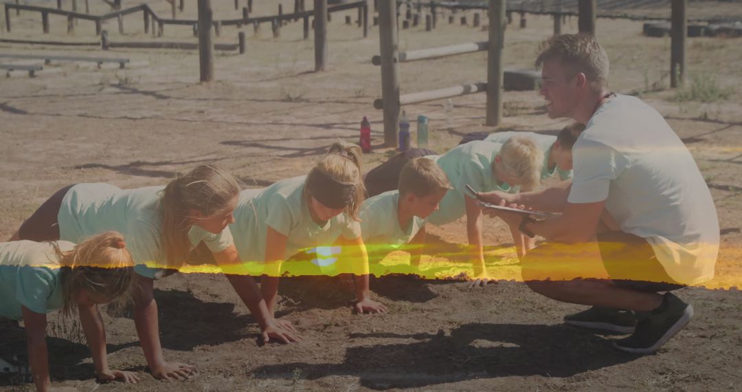 Children Exercising Push-Ups in Outdoor Obstacle Course