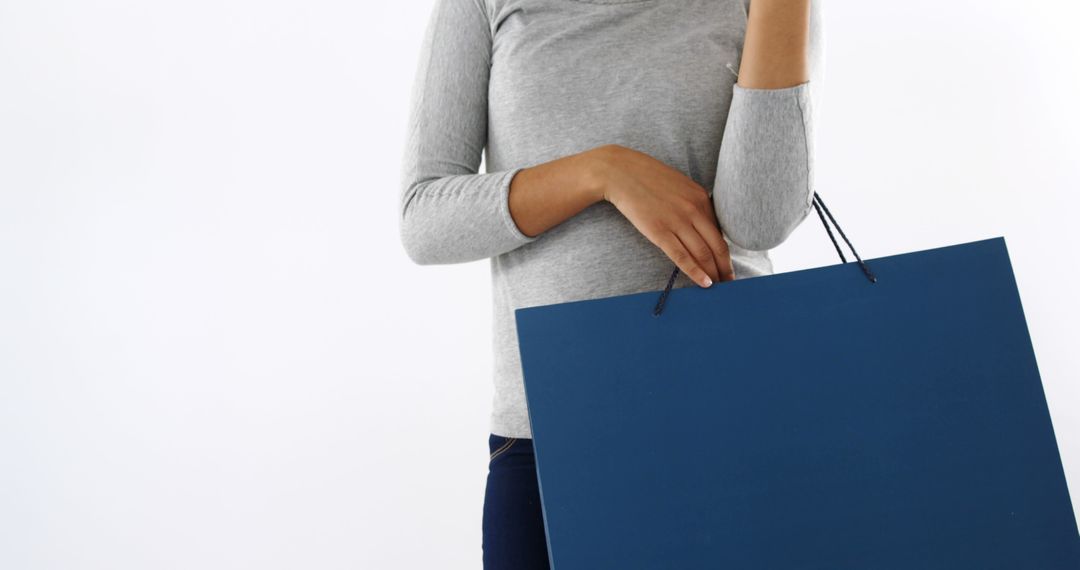 Woman Holding Large Blue Shopping Bag Against White Background - Free Images, Stock Photos and Pictures on Pikwizard.com