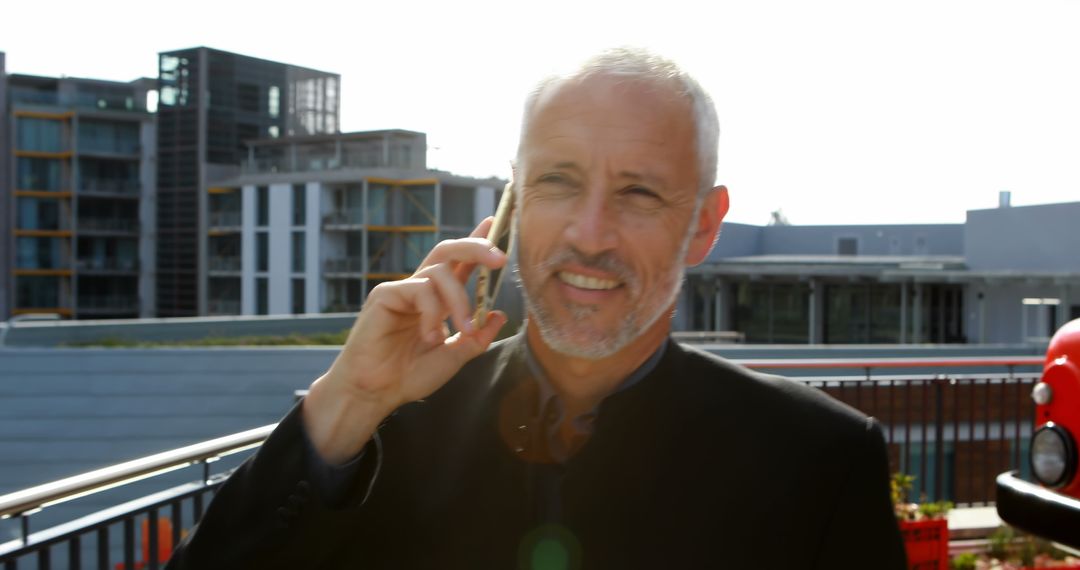 Confident Businessman Making Phone Call on Rooftop - Free Images, Stock Photos and Pictures on Pikwizard.com