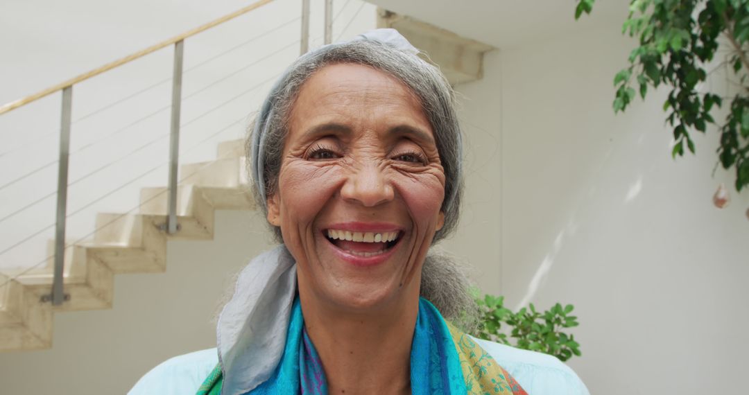 Elderly Woman Smiling Outdoors Against Minimalistic Staircase - Free Images, Stock Photos and Pictures on Pikwizard.com