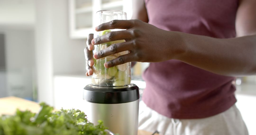 Close-up of person blending healthy smoothie with fresh greens - Free Images, Stock Photos and Pictures on Pikwizard.com