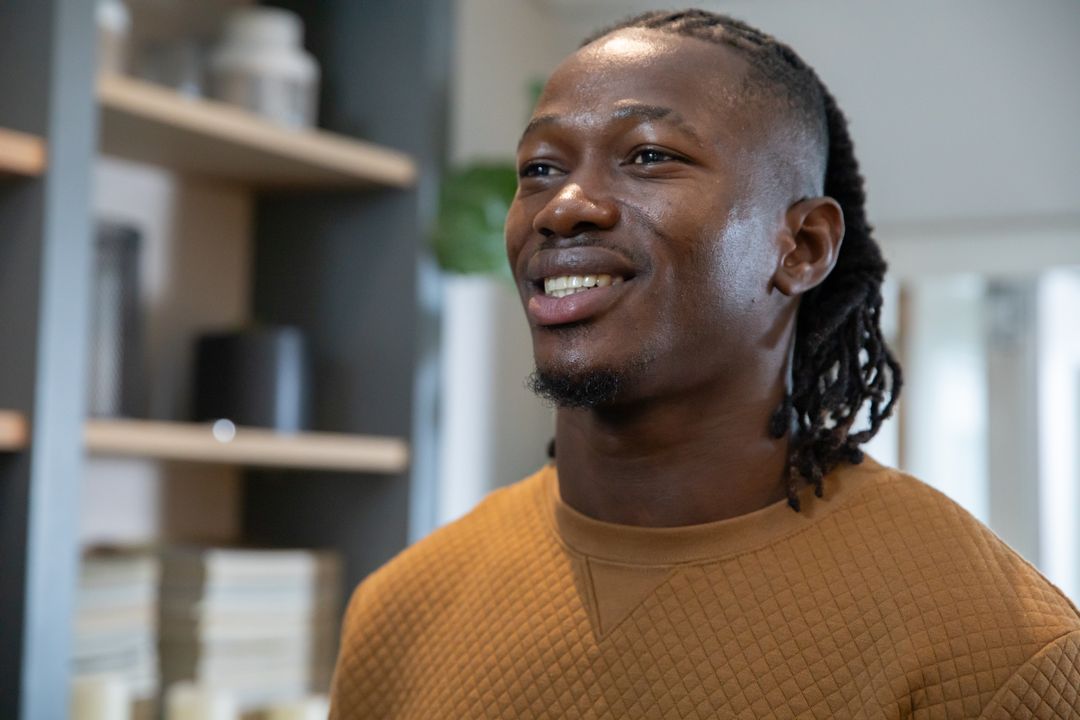 Smiling Man in Contemporary Office with Bookshelf Background