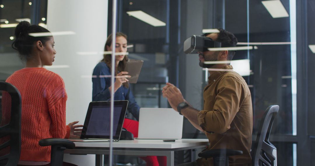 Team Collaborating with VR Headset in Modern Office - Free Images, Stock Photos and Pictures on Pikwizard.com