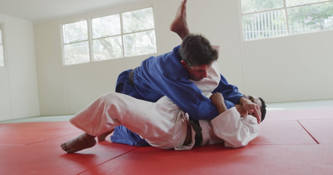 Martial Artists Practicing Judo on Red Mat During Training - Free Images, Stock Photos and Pictures on Pikwizard.com