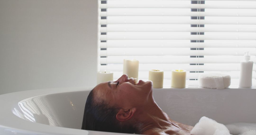 Woman Relaxing in Bathtub Near Candles - Free Images, Stock Photos and Pictures on Pikwizard.com