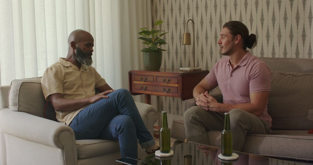 Men Socializing in Cozy Living Room Setting with Drinks