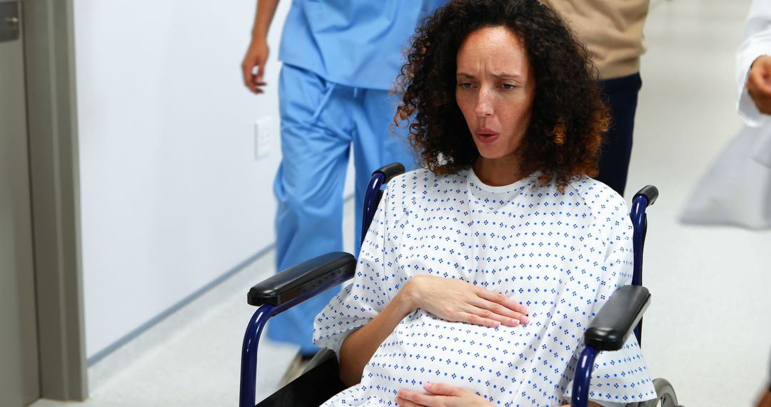 Pregnant Woman in Labor Being Wheeled Down Hospital Hallway - Free Images, Stock Photos and Pictures on Pikwizard.com