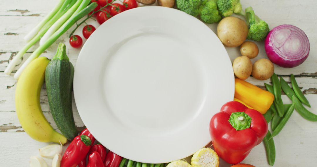 Empty plate surrounded by fresh vegetables on white wooden table - Free Images, Stock Photos and Pictures on Pikwizard.com