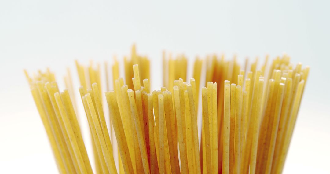 Close-up of Uncooked Spaghetti Sticks Against White Background - Free Images, Stock Photos and Pictures on Pikwizard.com