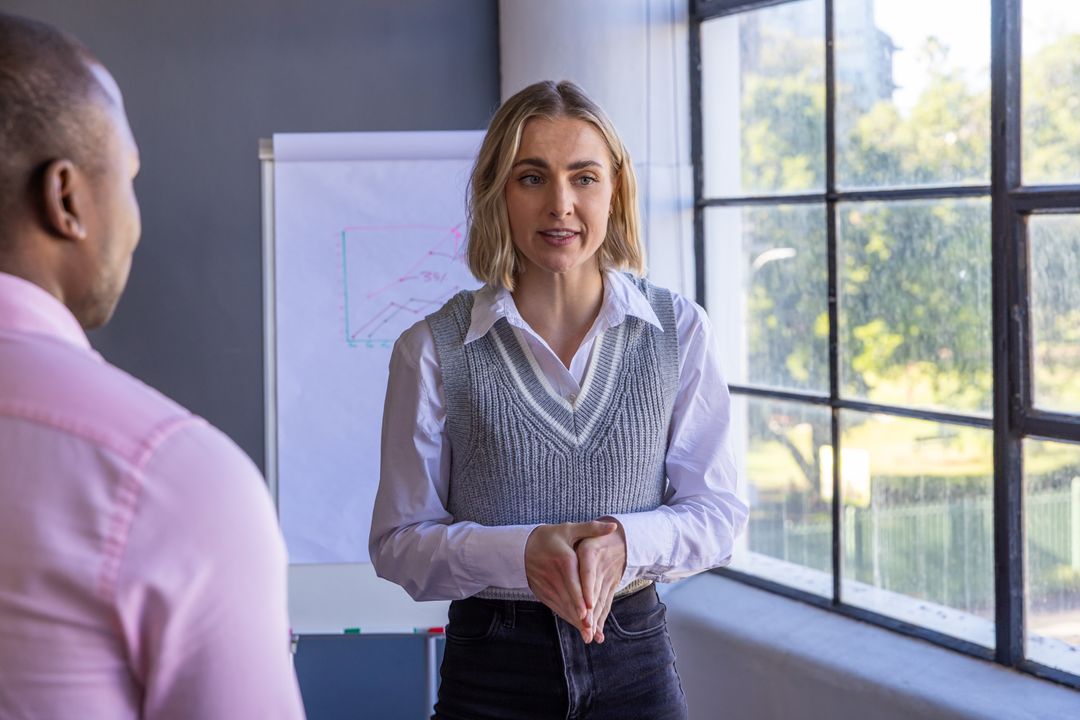 Diverse Professionals Engaged in Data Presentation Meeting with Analytics