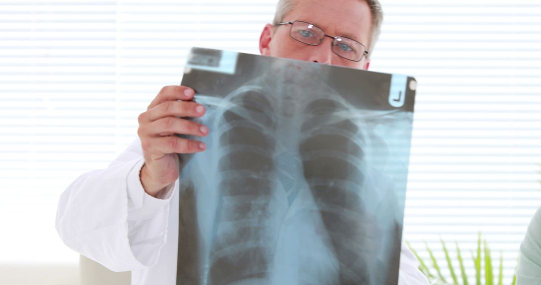 Doctor Examining Chest X-Ray in Hospital Room - Free Images, Stock Photos and Pictures on Pikwizard.com