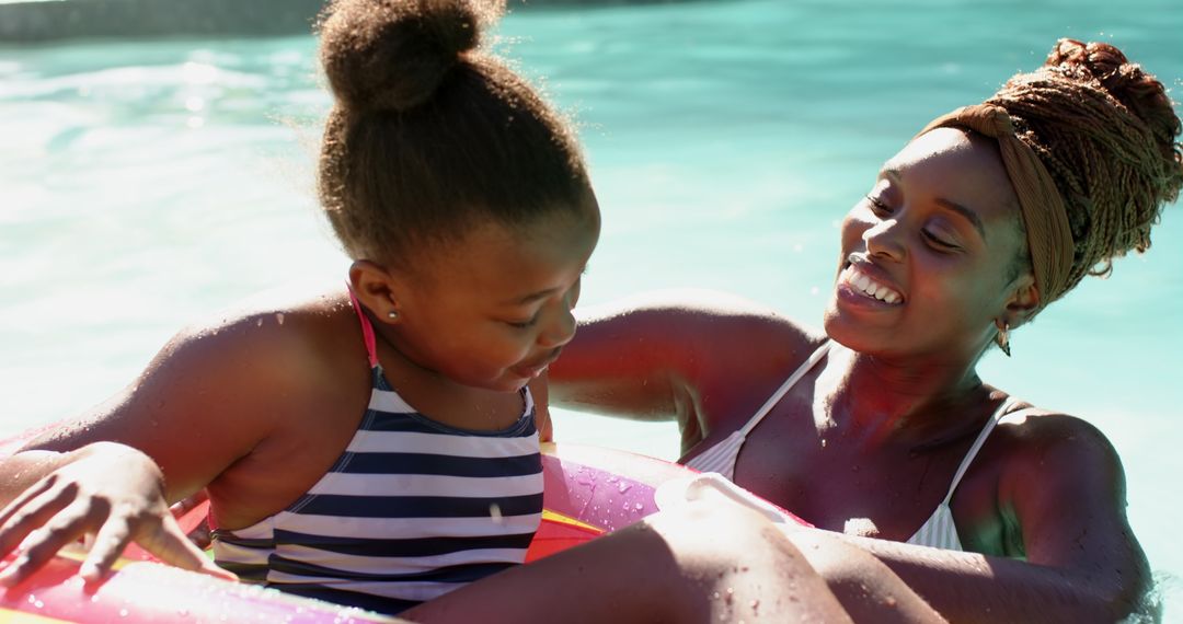 Mother and Daughter Enjoying Summer Pool Time in Sunlight