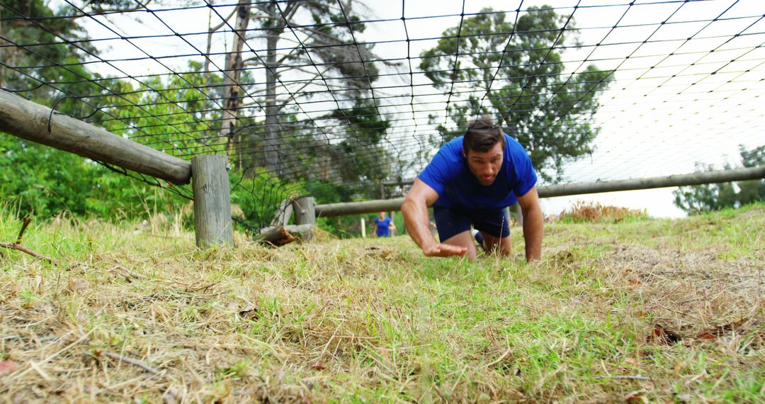 Man Crawling Through Rope Obstacle on Outdoor Fitness Course - Free Images, Stock Photos and Pictures on Pikwizard.com