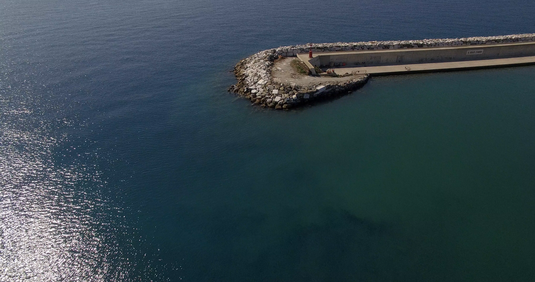 Transparent Blue Ocean Meeting Rocky Pier in Sunny Coastal Setting - Download Free Stock Images Pikwizard.com