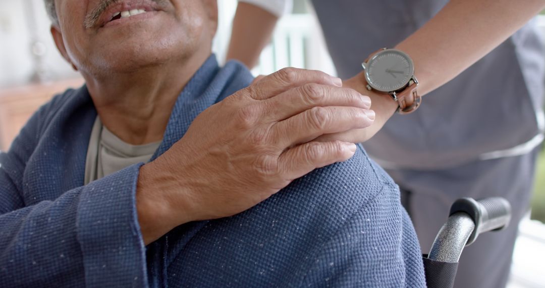 Caregiver Supporting Elderly Person in Wheelchair with Gentle Touch - Free Images, Stock Photos and Pictures on Pikwizard.com