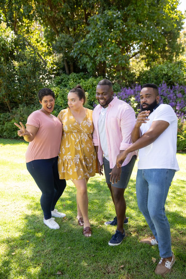 Diverse Friends Posing Happily in Sunny Backyard Garden